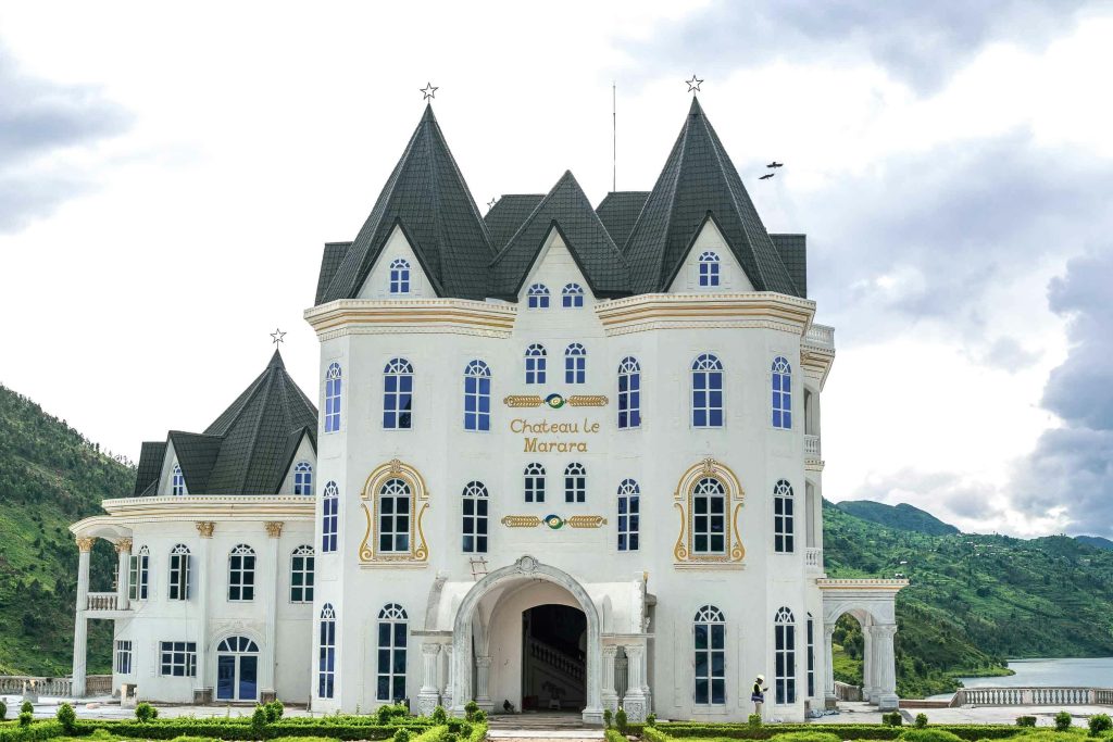 Chateau Le Marara standing majestically in Kibuye, Rwanda with lush green surroundings.
